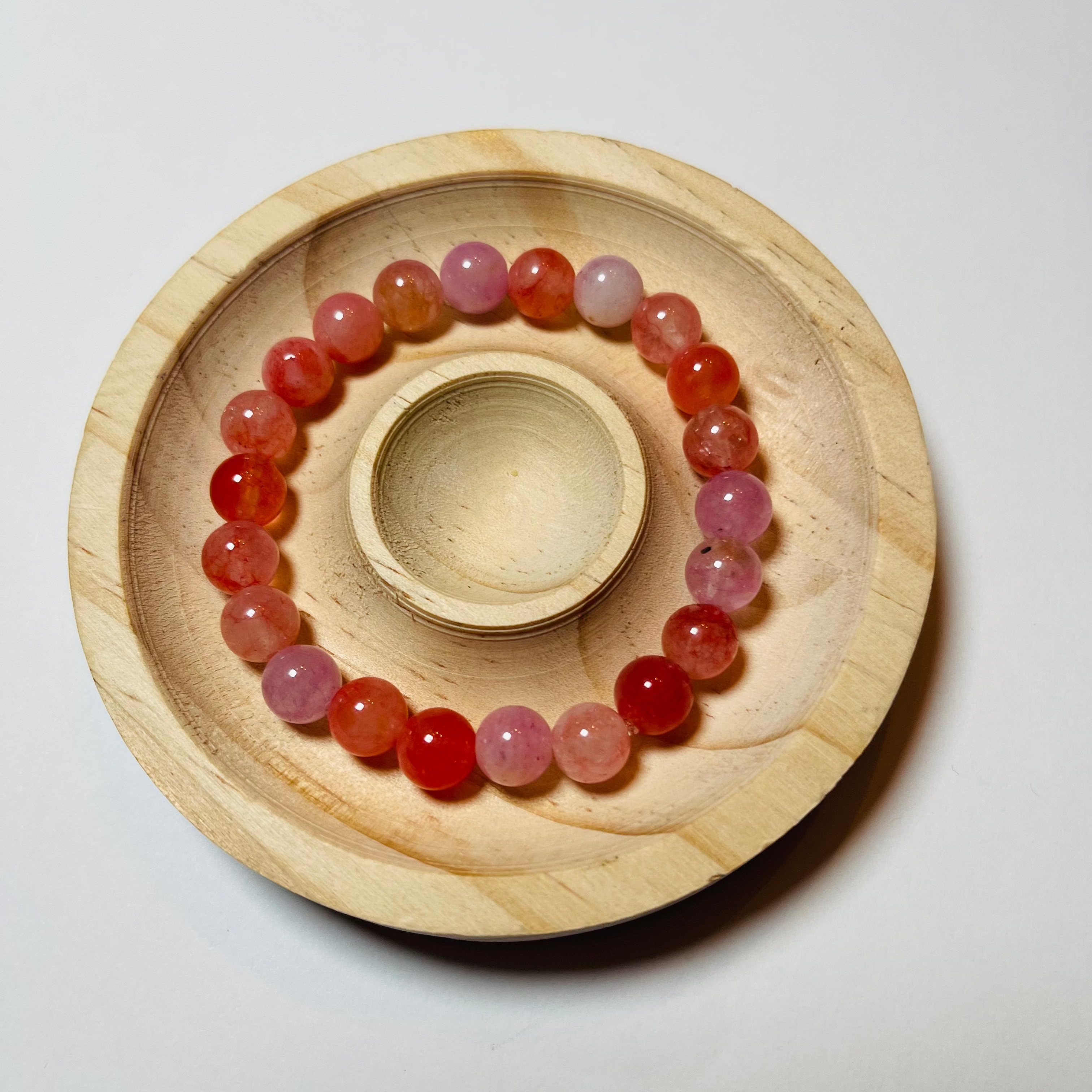 Beaded bracelet on a wooden stand against a white background