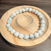 White beaded bracelet on a wooden coaster