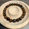 Beaded bracelet on a wooden and stone surface