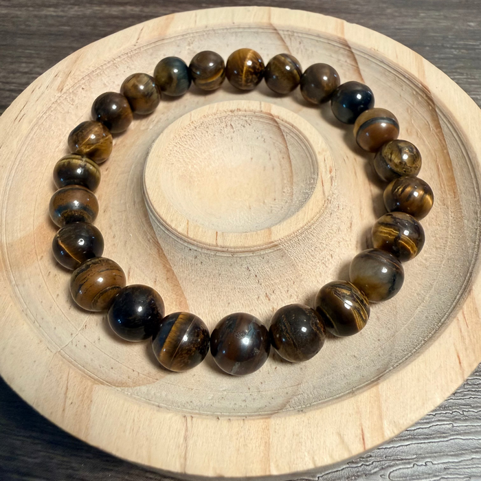 Beaded bracelet on a wooden and stone surface