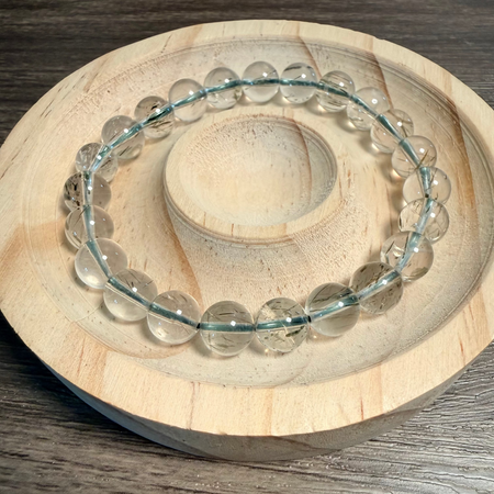 Clear beaded bracelet on a wooden surface