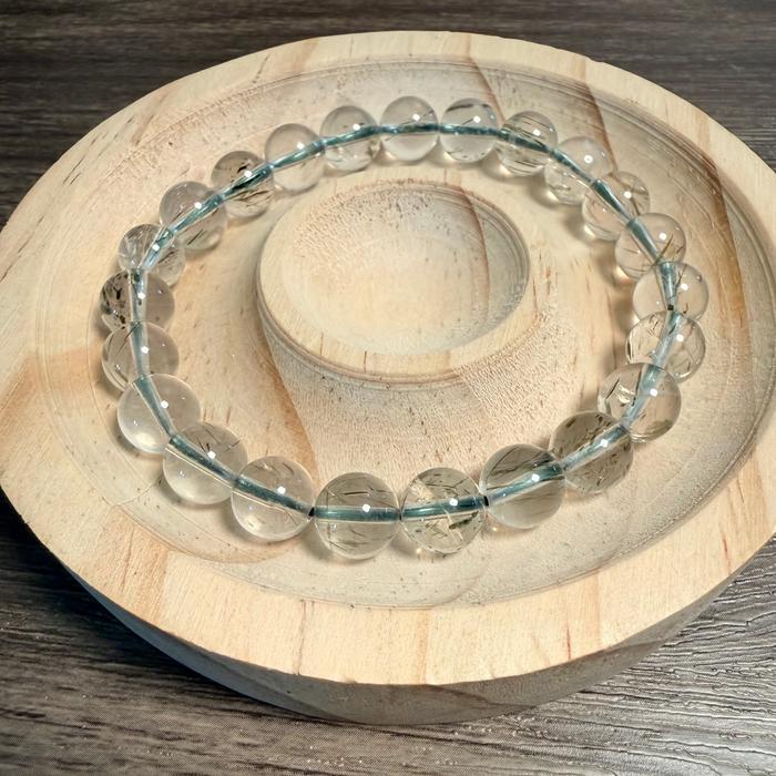 Clear beaded bracelet on a wooden surface